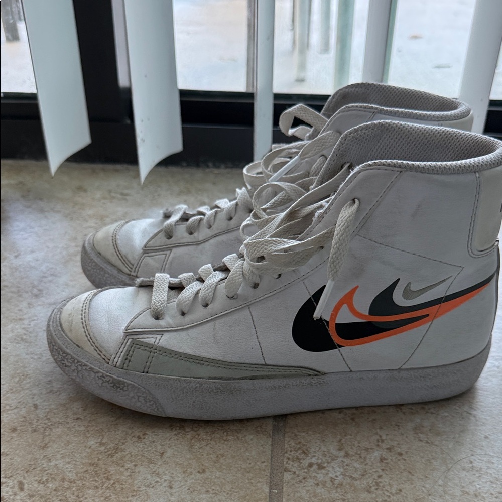 Nike Men's White and Black High-Top Sneakers with Orange Swoosh